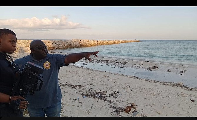 Officers can be seen surveying the area where a man's body was found floating in waters on June 3.