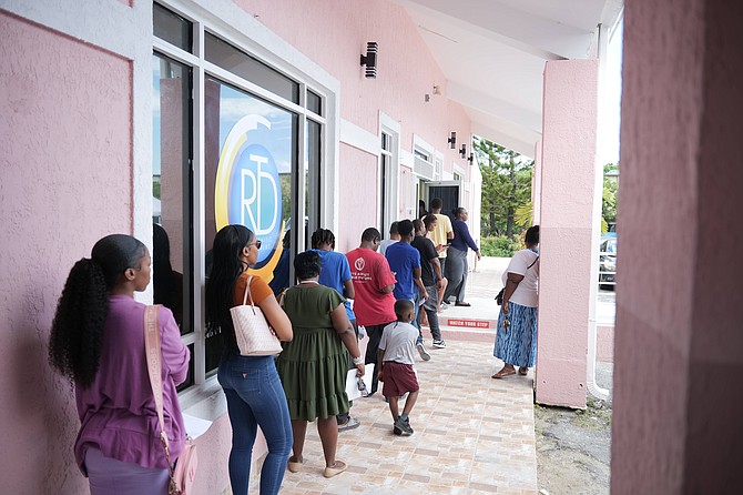 The Public waiting in line at the new Road Traffic Department location on Tonique Williams-Darling Hwy yesterday.