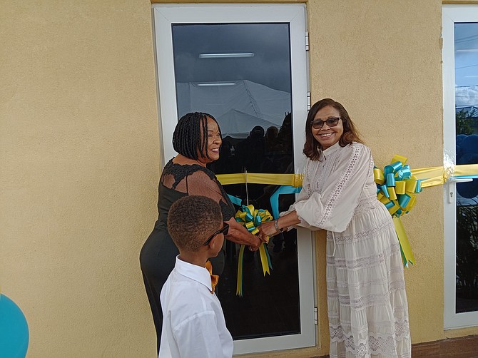 Arlene Sands (right), community service director at Freeport Seventh Day Adventist Church, and Estella Glinton, the daughter of Evangeline Jervis, cut the ribbon to open the shelter officially.