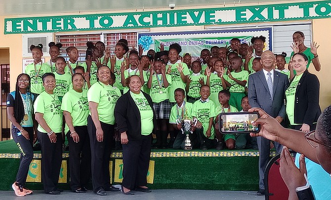 Cleveland Eneas track team, administration and staff celebrate their eighth victory with Pinewood MP Myles LaRoda.