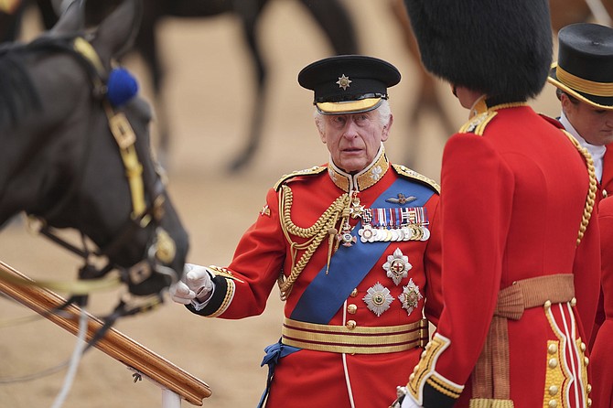 Britain's King Charles III arrives for the Trooping the Color ceremony at Horse Guards Parade, London, Saturday, June 15, 2024. (Yui Mok/PA via AP)