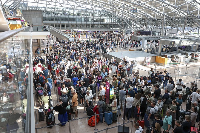 Travelers wait in Terminal 1 for check-in at Hamburg Airport, in Hamburg, Germany, Friday July 19, 2024 as a widespread Microsoft outage disrupted flights, banks, media outlets and companies around the world on Friday. (Bodo Marks/dpa via AP)