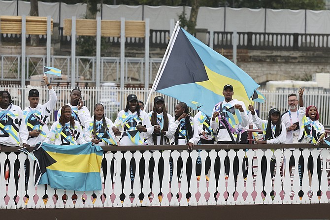 TEAM BAHAMAS athletes travel along the Seine River in Paris, France, during the opening ceremony for the 2024 Summer Olympics on Friday, July 26, 2024. (Nir Elias/Pool Photo via AP)