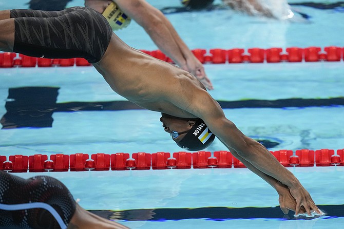 Lamar Taylor, of Bahamas, competes during a heat in the men's 100-meter freestyle at the 2024 Summer Olympics, Tuesday, July 30, 2024, in Nanterre, France. (AP Photo/Bernat Armangue)