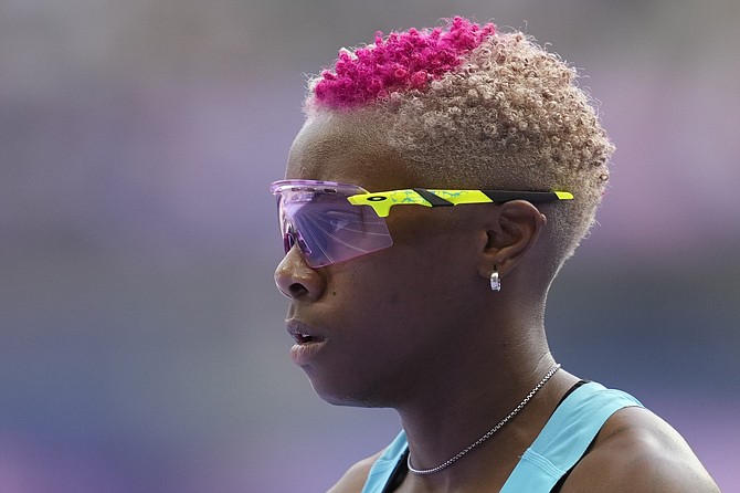 Devynne Charlton, of Bahamas, reacts after her women's 100-meter hurdles heat at the 2024 Summer Olympics, Wednesday, Aug. 7, 2024, in Saint-Denis, France. (AP Photo/Ashley Landis)