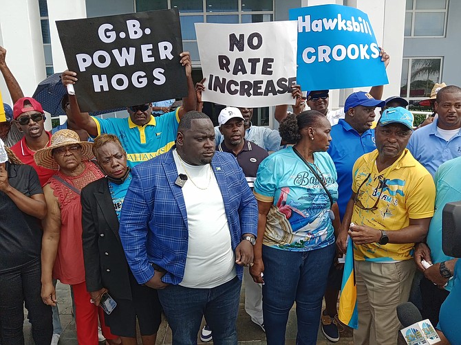 Former FNM vice-chair Richard Johnson (blue patterned jacket) leads a protest in Grand Bahama against the electricity rate increase proposed by the Grand Bahama Power Company.