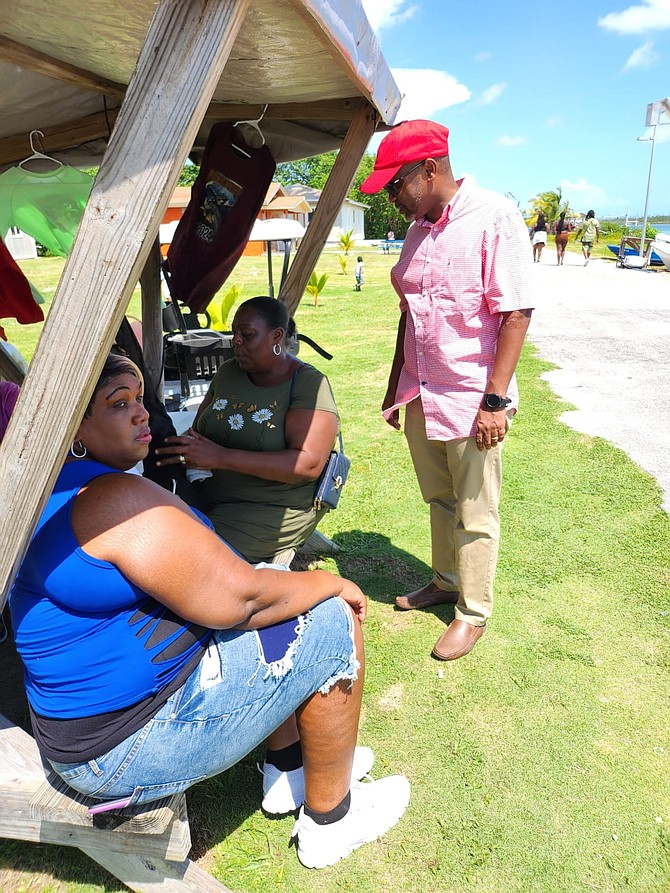 East Grand Bahama MP Kwasi Thompson speaks with vendors at the Sweeting’s Cay homecoming festival on Saturday.