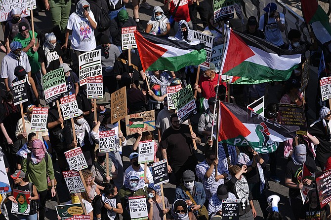 Protesters march to the Democratic National Convention after a rally at Union Park Monday, Aug. 19, 2024, in Chicago. (AP Photo/Julio Cortez)