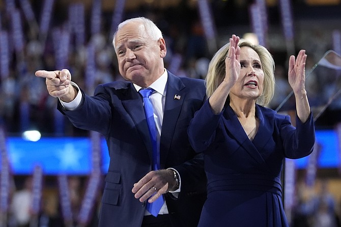 Democratic vice presidential nominee Minnesota Gov. Tim Walz and wife Gwen react during the Democratic National Convention Wednesday, Aug. 21, 2024, in Chicago. (AP Photo/Paul Sancya)