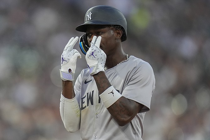 New York Yankees' Jazz Chisholm Jr. celebrates after scoring on a single by Anthony Volpe during the fifth inning of a baseball game against the Chicago White Sox, Monday, Aug. 12, 2024, in Chicago. (AP Photo/Erin Hooley)