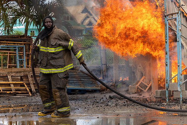 Firefighters work to suppress a fire that destroyed a building used for storage at Sapodilla on August 27, 2024. Photo: Dante Carrer/Tribune Staff