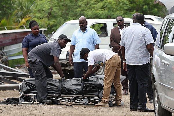 The scene on an unnamed road opposite Ramsey Street off Carmichael Road where a man was shot and killed yesterday. Photo: Dante Carrer/Tribune Staff