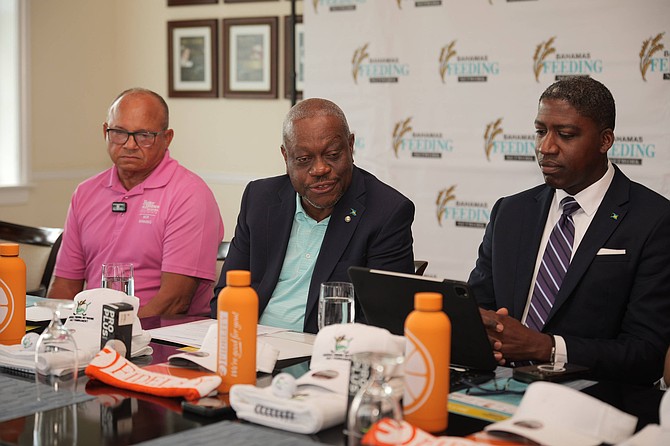 Felix Stubbs (center), Bahamas Feeding Network chairman, speaking to reporters during a press conference yesterday. Photo: Chappell Whyms Jr