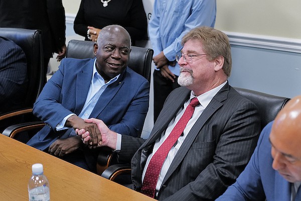 Prime Minister Philip “Brave” Davis shakes hands with Consolidated Water President and CEO Frederick McTaggart during a contract signing ceremony between the WSC and Consolidated Water at the Office of The Prime Minister yesterday. Photo: Dante Carrer/Tribune Staff