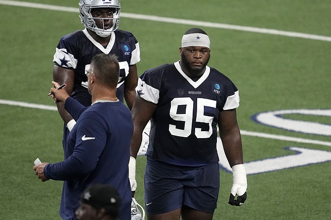 Dallas Cowboys defensive tackle Denzel Daxon takes a break from drills during an NFL football practice, Wednesday, Aug. 28, 2024, in Frisco, Texas.(AP Photo/Tony Gutierrez)