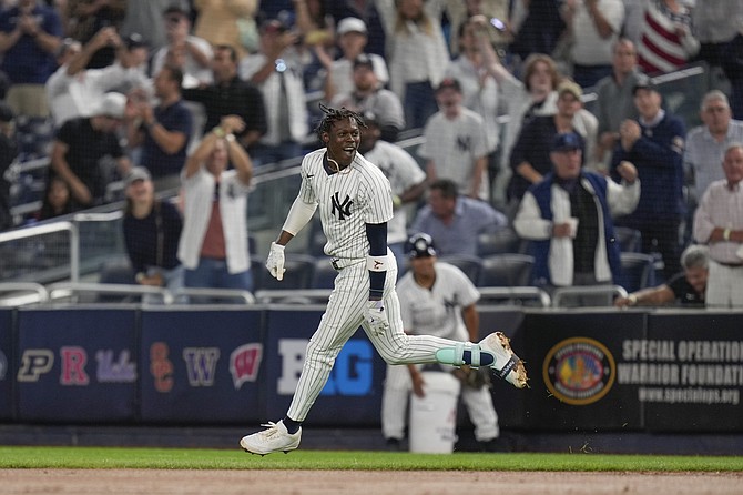 New York Yankees' Jazz Chisholm Jr. celebrates after hitting a walk-off RBI single during the 11th inning of a baseball game against the Kansas City Royals at Yankee Stadium Wednesday, Sept. 11, 2024, in New York. (AP Photo/Seth Wenig)