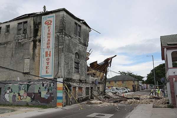 The historic Reinhard Hotel collapsed yesterday, blocking Baillou Hill Road with debris and damaging a neighbouring home. Photo Dante Carrer/Tribune Staff