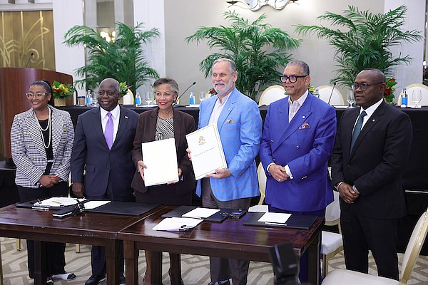 Director of Investments Phylicia Woods, Prime Minister Philip "Brave" Davis, Permanent Secretary Nicole Campbell, Baha Mar President Graeme Davis, Bahamas Hotel and Tourism Association President Robert "Sandy" Sands and Deputy Prime Minister and Minister of Tourism, Investment and Aviation Chester Cooper during a heads of agreement (HOA) signing between the Government and Baha Mar for the hotel’s expansion at Rosewood on September 18, 2024. Photo: Dante Carrer/Tribune Staff