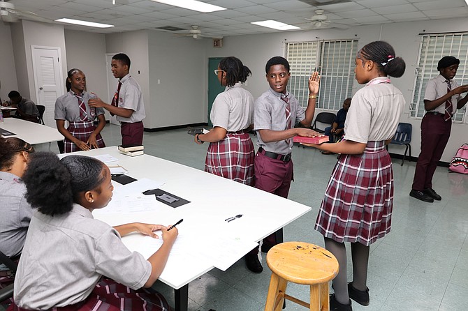 Students taking the oath, above, and, below, registering for the junior council elections.