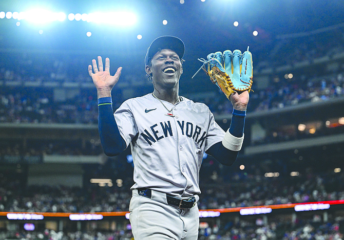 Yankees’ Jazz Chisholm Jr. laughs with fans as he exits the field at the end of a baseball game against the Texas Rangers on September 2. Last night, Chisholm Jr and the Yankees beat the Baltimore Orioles 10-1 to clinch the AL East title. (AP Photo/Albert Pena)