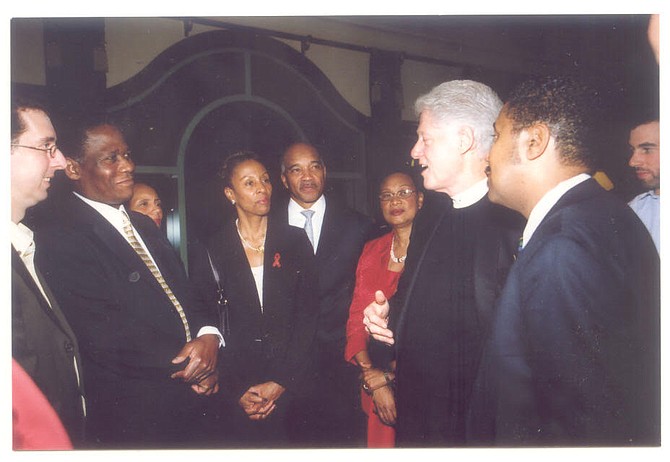 Former United States President Bill Clinton, second to right; Camille, Lady Barnett, center, wearing the AIDS ribbon; Dame Anita Allen, Dr Marcus Bethel, Dr Perry Gomez and others hold a conversation about the success of The Bahamas in fighting HIV/ AIDS.