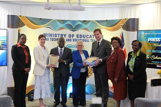 Baroness Jennifer Chapman and British High Commissioner Thomas Hartley give archival gifts to Prime Minister Philip ‘Brave’ Davis and Education Minister Glenys Hanna Martin at the Ivy Dumont Lobby yesterday.
Photo: Chappell Whyms Jr