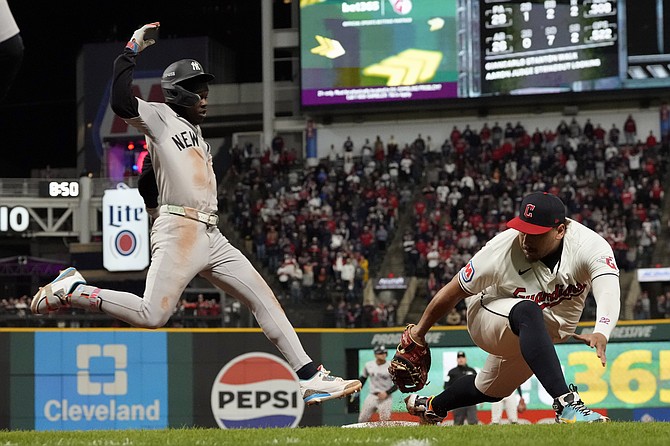 Yankees’ Jazz Chisholm Jr, left, is out at first as Guardians first baseman Josh Naylor stretches to touch the bag during the 10th inning in Game 3 of the baseball AL Championship Series Thursday, October 17, 2024, in Cleveland. (AP Photo/Godofredo Vásquez)