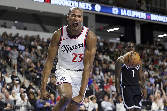 Los Angeles Clippers forward Kai Jones reacts after dunking the ball during the second half of a preseason NBA basketball game against the Brooklyn Nets, Tuesday, Oct. 8, 2024, in Oceanside, Calif. (AP Photo/Ryan Sun)