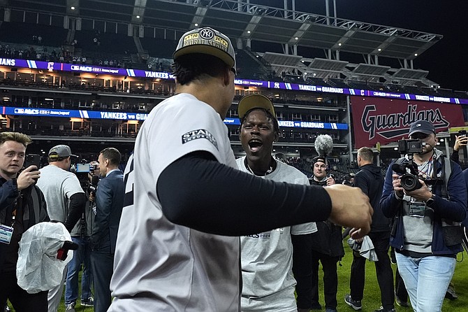 New York Yankees' Jazz Chisholm Jr., right, and Juan Soto celebrate after Game 5 of the baseball AL Championship Series against the Cleveland Guardians Saturday, Oct. 19, 2024, in Cleveland. (AP Photo/Godofredo A. Vásquez)