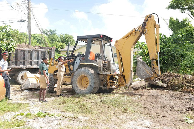 Assistant Superintendent McKell Pinder, who leads the Englerston Urban Renewal initiative, on the scene during a walkabout of the area as the government’s ‘Clear, Hold, Build’ strategy begins efforts to help residents feel safer by clearing hazardous properties linked to criminal activity. See PAGE TWO for story. Photo: Nikia Charlton