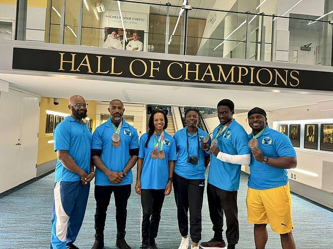 MEDAL MEN AND WOMEN: Shown, from left to right, team head coach and BBWFF president Wellington “Cat” Sears, athletes Wellington Wallace and Jackie Cleare, assistant team manager Jahmennen Forbes, and athletes Alexander Kemp and Rashad Cunningham.