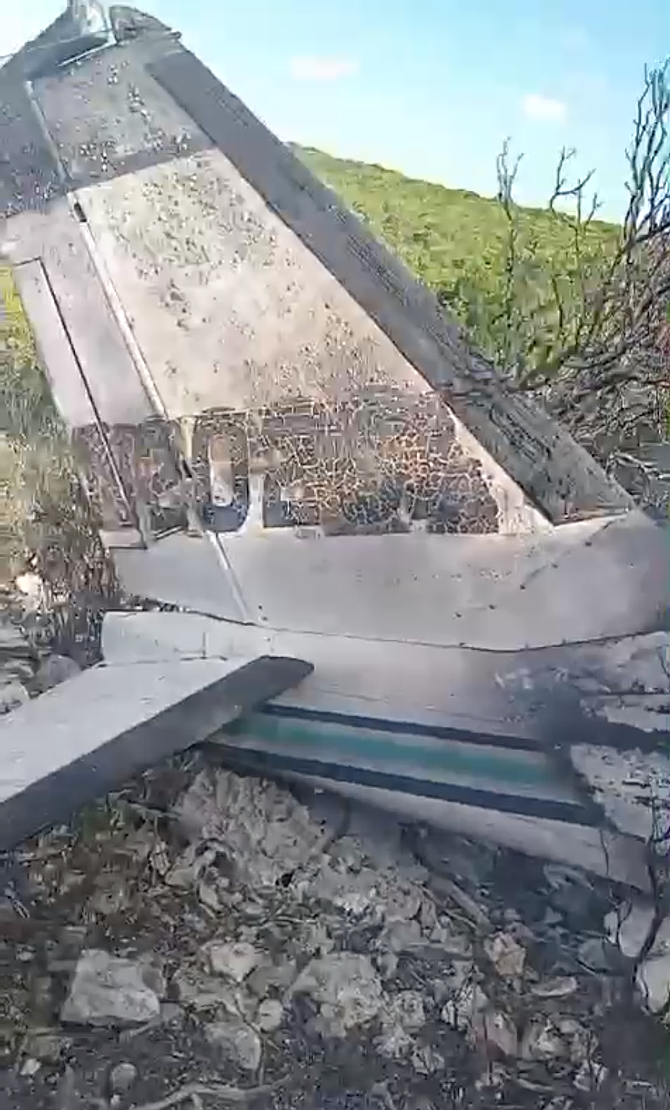 The tail section of a burned plane as seen in a video circulation on social media after the Ragged Island crash.