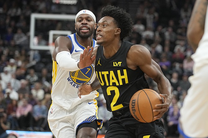 Utah Jazz guard Collin Sexton (2) drives to the basket as Warriors guard Buddy Hield (7) defends in the first half on Friday, October 25, 2024, in Salt Lake City. (AP Photo/George Frey)