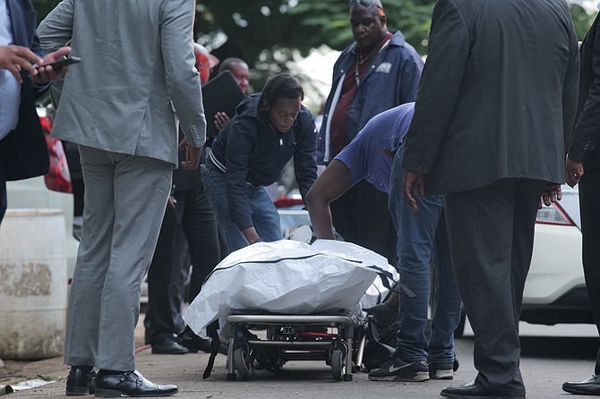 A body is taken from the scene in Step Street in Fox Hill after three people were shot dead on Monday. 
Photo: Nikia Charlton