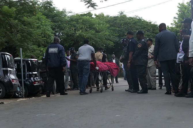 A body is taken from the scene in Step Street in Fox Hill after three people were shot dead on Monday. Photo: Nikia Charlton