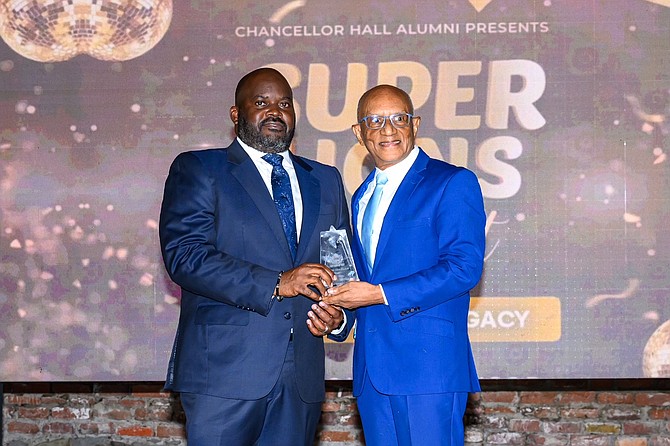 Super Lion awardee Sir Ian Winder, Chief Justice of The Bahamas, receives his award from fellow Super Lion Professor Trevor Munroe.