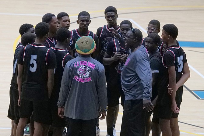 CR Walker senior boys head coach Trevor Grant makes in-game adjustments against the CI Gibson Rattlers last night. The Knights won 2-1 in a three-set thriller. Photo: Nikia Charlton