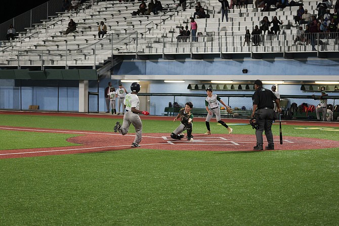 High school students in action yesterday in game one of the BAISS best-of-three baseball championship series at the Andre Rodgers Baseball Stadium. Photos: Chappell Whyms Jr