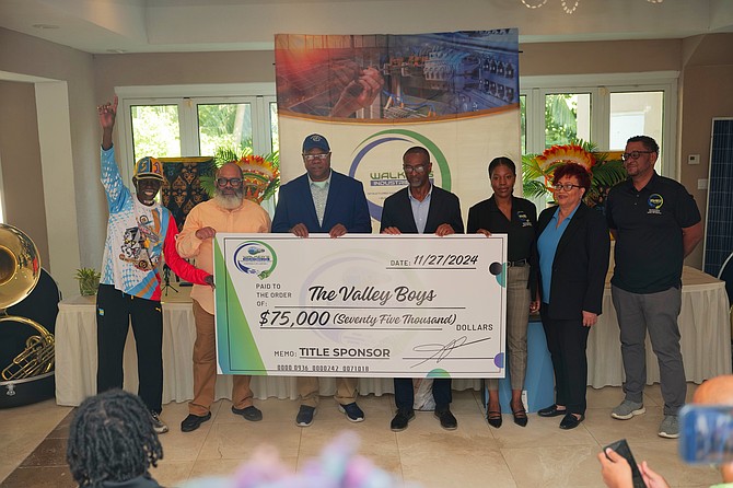 Leader of the World Famous Valley Boys Brian Adderley (centre left) receives a check for $75,000 from Walker Industries general manager Dolan Russell yesterday. Photo: Nikia Charlton