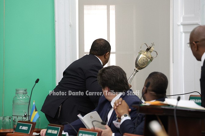 Shanendon Cartwright throwing the mace from the window of the House of Assembly. 

Photo: Dante Carrer/Tribune Staff