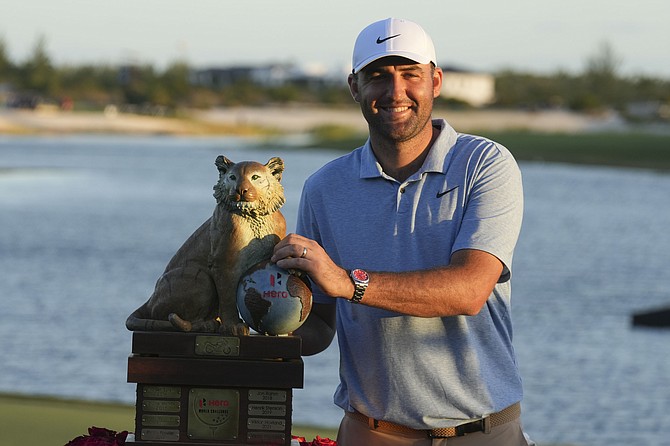 Scottie Scheffler, of the United States, poses with the championship trophy yesterday after the final round of the Hero World Challenge PGA Tour at the Albany Golf Club. (AP Photos/Fernando Llano)