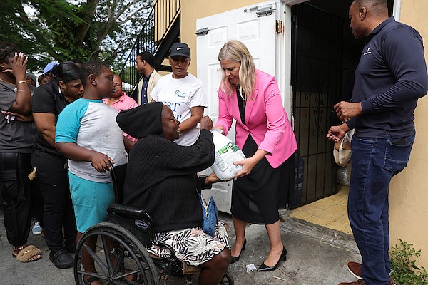 US Chargé d’Affaires Kimberly Furnish helps to distribute turkeys during an event to mark the donation to Bahamas Feeding Network by Royal Caribbean on December 16, 2024. Photo: Dante Carrer/Tribune Staff