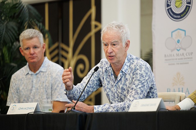 Tennis legend John McEnroe, right, speaks as Mark Knowles looks on.