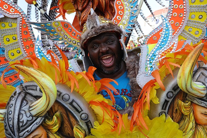 An enthusiastic member of the Shell Saxon Superstars rushes on Bay Street during the New Year’s Day Junkanoo Parade as the group captured their fourth straight Junkanoo title making history. Photo: Dante Carrer/Tribune Staff