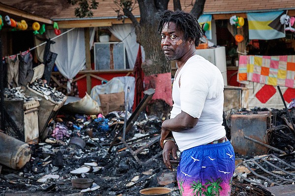 Stanley Minnis searches through the rubble of Eljhay’s Hilltop Cottage Ministries which was destroyed by fire on January 31, 2025. Mr Minnis received burns to his shoulder and face during the fire. Photo: Dante Carrer/Tribune Staff