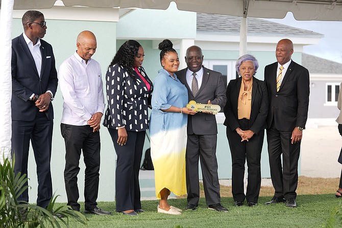 Barricka Butler (centre) recieves the key for her new home. Photos: Chappell Whyms Jr