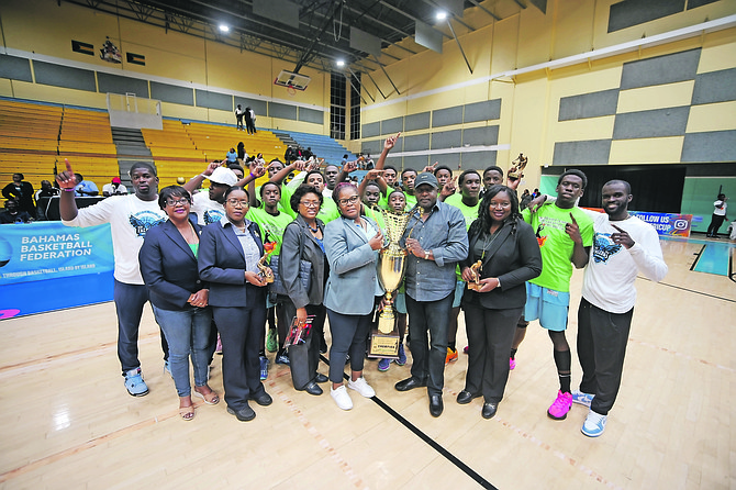 The Tabernacle Baptist Academy Falcons celebrate with Minister of Youth, Sports and Culture Mario Bowleg and their championship trophy after beating the CI Gibson Rattlers in the grand finale of the 41st Hugh Campbell Basketball Classic at the Kendal Isaacs Gymnasium on February 24, 2025. Photo: Chappell Whyms Jr