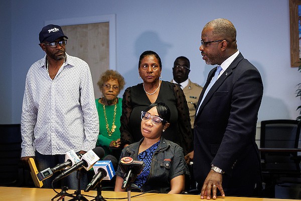 Latasha Rolle, Delano Clarke and Minister of National Security Wayne Munroe KC during a press conference where the Bahamas Crisis Centre presented the Good Samaritan Award to Mr Clarke at the Ministry of National Security on February 28, 2025. Photo: Dante Carrer/Tribune Staff