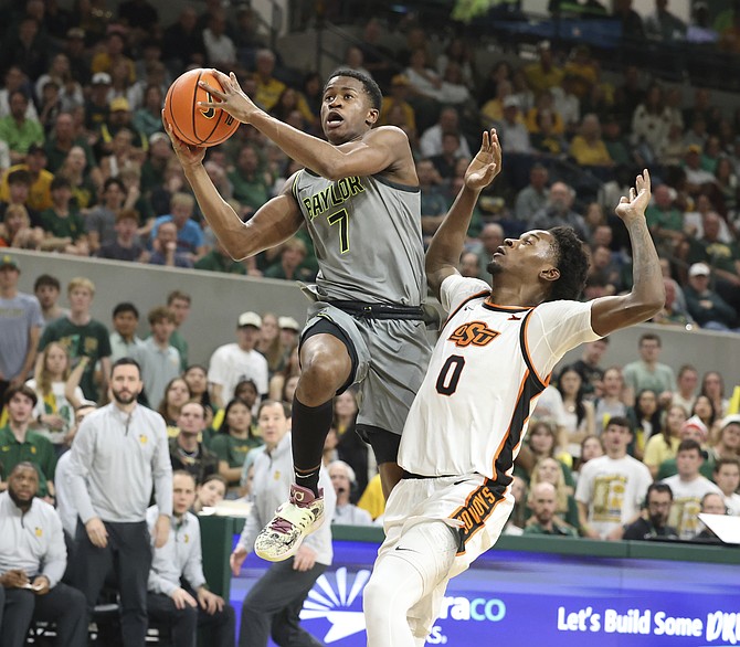 Baylor guard VJ Edgecombe, left, slips past Oklahoma State forward Marchelus Avery while driving to the basket in the second half of an NCAA college basketball game, Saturday, March 1, 2025, in Waco, Texas. (Rod Aydelotte/Waco Tribune-Herald via AP) /Waco Tribune-Herald via AP)