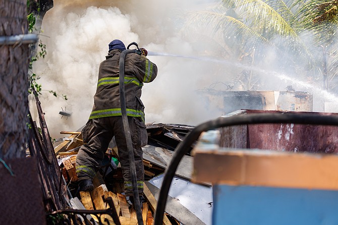 Firefighters battling the blaze on Monday, April 14. 
Photo: Dante Carrer/Tribune Staff